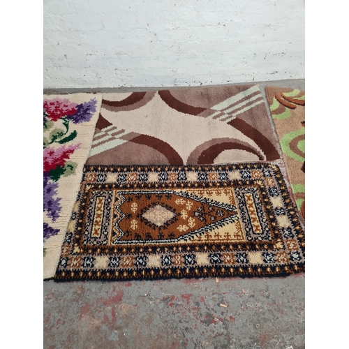 100 - Four mid 20th century woollen rugs