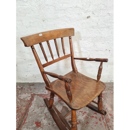 102 - A 19th century elm and beech child's rocking chair