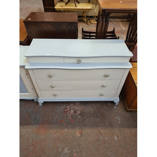 105 - Two pieces of mid 20th century white and pale blue painted furniture, one chest of drawers and one b... 