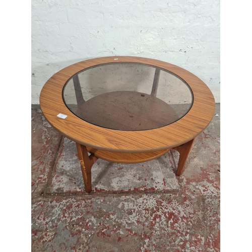 107 - A mid 20th century teak effect and smoked glass circular two tier coffee table - approx. 45cm high x... 