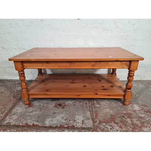 114 - A modern pine rectangular two tier coffee table - approx. 46.5cm high x 55cm wide x 105cm long