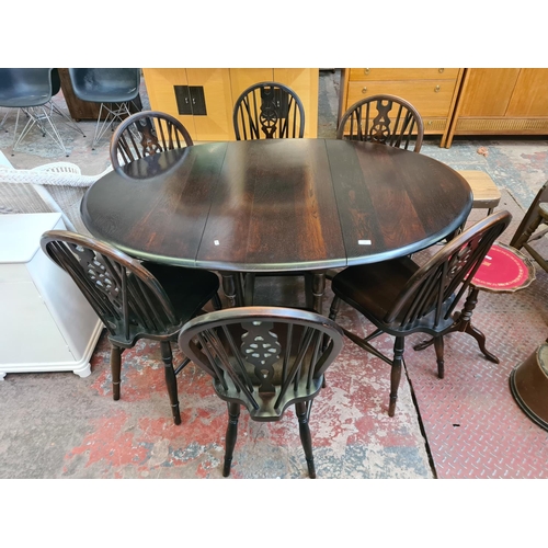 122 - An oak drop leaf gate leg oval dining table and six matching wheelback dining chairs - approx. 75cm ... 