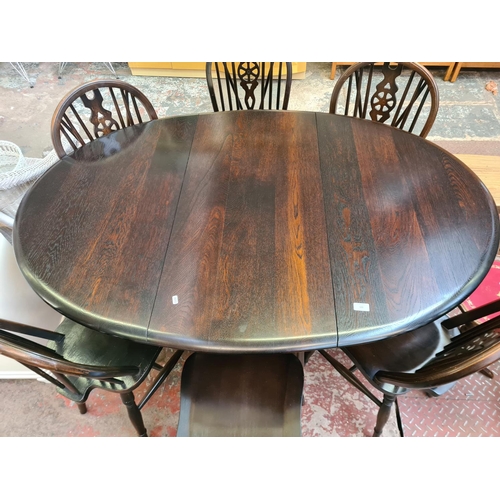 122 - An oak drop leaf gate leg oval dining table and six matching wheelback dining chairs - approx. 75cm ... 