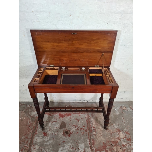 125 - A Victorian Aesthetic Movement mahogany writing table with fitted interior, lower stretcher and cast... 