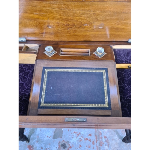 125 - A Victorian Aesthetic Movement mahogany writing table with fitted interior, lower stretcher and cast... 