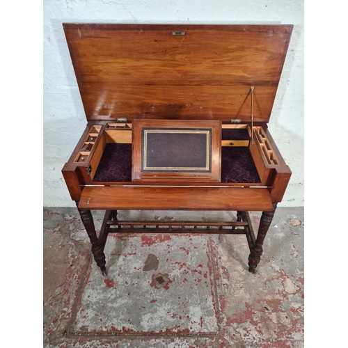 125 - A Victorian Aesthetic Movement mahogany writing table with fitted interior, lower stretcher and cast... 