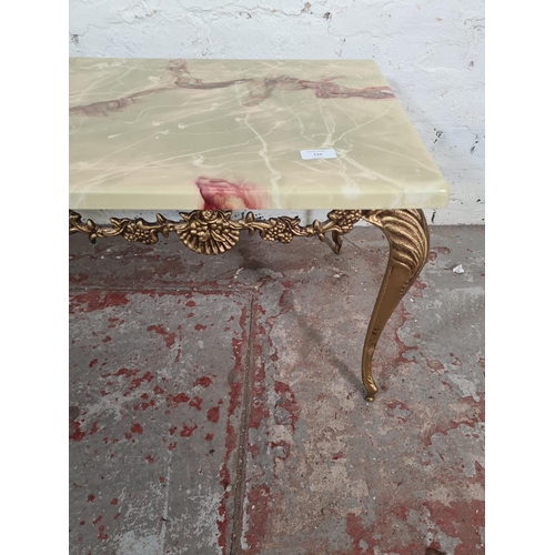 134 - An onyx effect and gilt metal rectangular coffee table - approx. 40cm high x 45cm wide x 91cm long