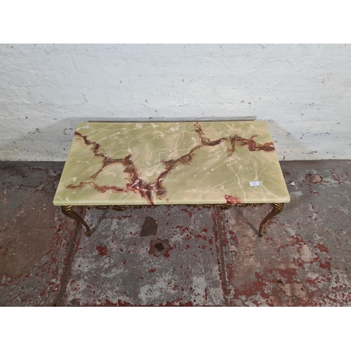 134 - An onyx effect and gilt metal rectangular coffee table - approx. 40cm high x 45cm wide x 91cm long