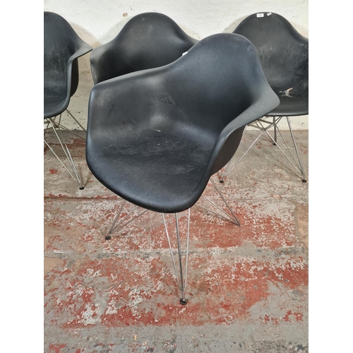 139 - Four Eames style black plastic dining chairs