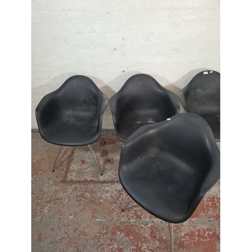 139 - Four Eames style black plastic dining chairs