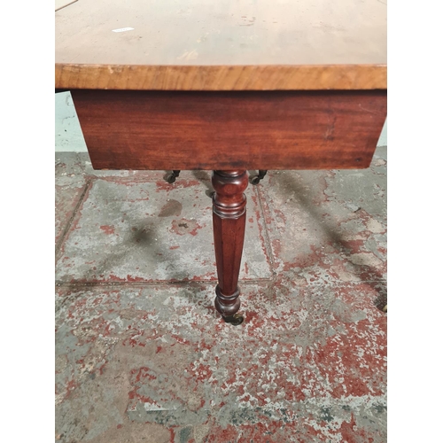 14 - A Victorian mahogany drop leaf gate leg dining table with original brass castors - approx. 74cm high... 