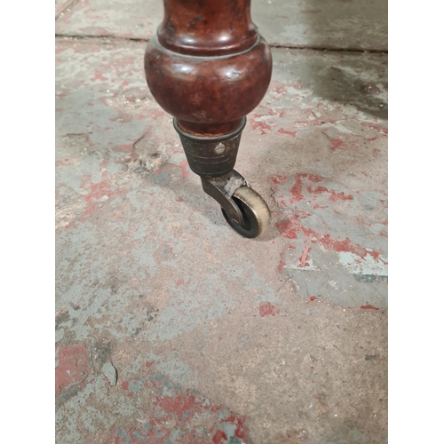 14 - A Victorian mahogany drop leaf gate leg dining table with original brass castors - approx. 74cm high... 