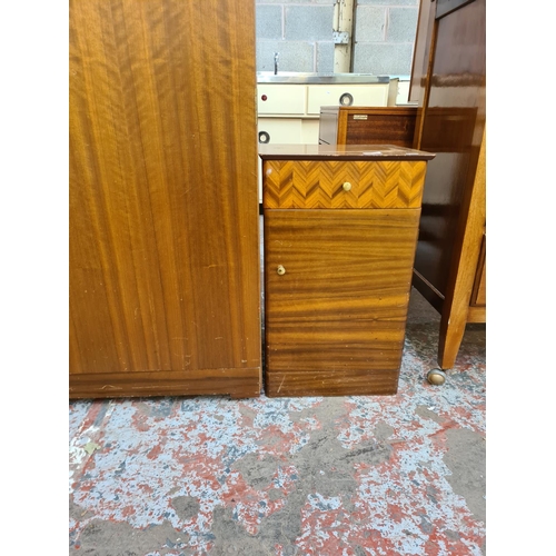 141 - A mid 20th century Uniflex walnut two piece bedroom suite comprising double wardrobe and bedside cab... 