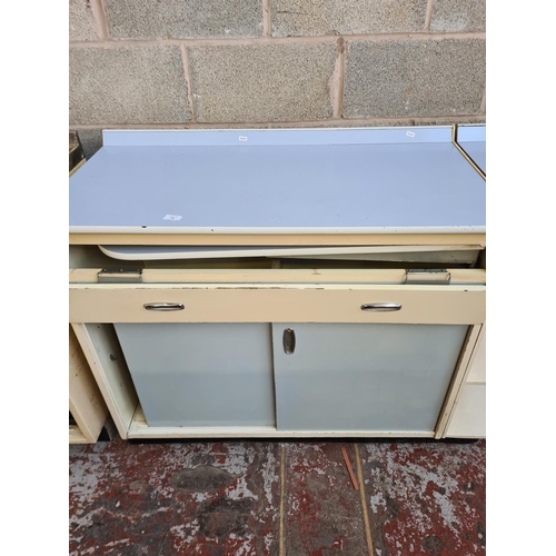 146 - A 1950s pale blue and white laminate kitchen cabinet with foldout side table, two sliding doors and ... 