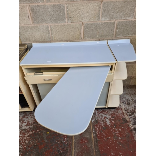 146 - A 1950s pale blue and white laminate kitchen cabinet with foldout side table, two sliding doors and ... 