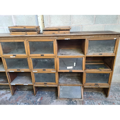 147 - An early 20th century oak twenty four section barristers bookcase - approx. 131cm high x 310cm wide ... 