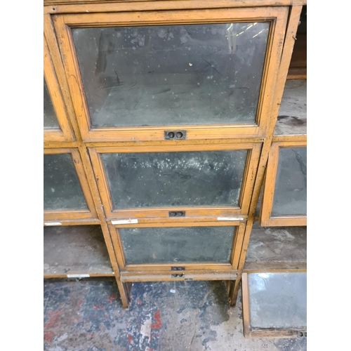 147 - An early 20th century oak twenty four section barristers bookcase - approx. 131cm high x 310cm wide ... 