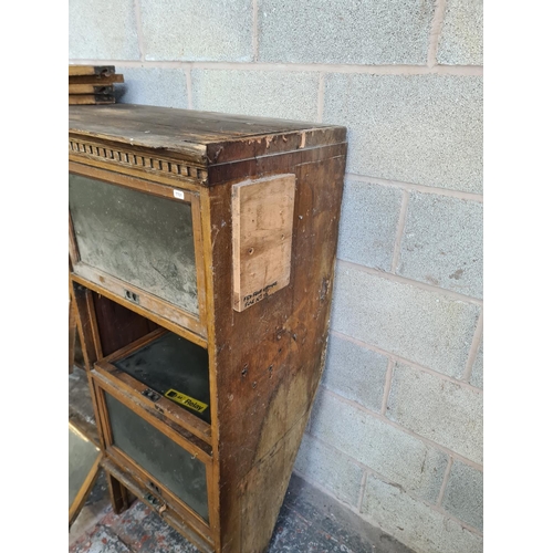 147 - An early 20th century oak twenty four section barristers bookcase - approx. 131cm high x 310cm wide ... 