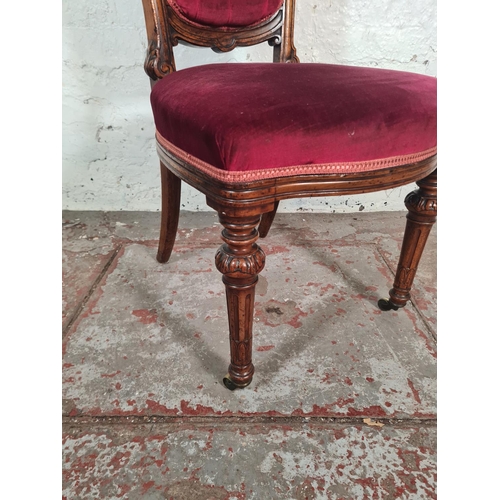 15 - A Victorian mahogany and velvet upholstered dining chair with fluted supports and brass castors