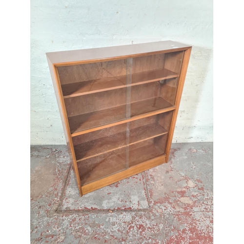 17 - A Herbert Gibbs teak four tier bookcase with four glass sliding doors - approx. 112cm high x 91cm wi... 