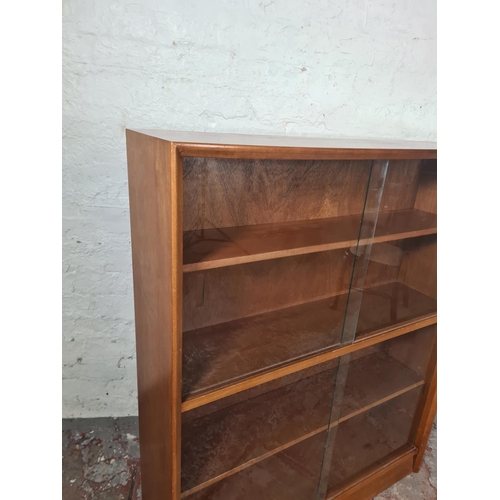 17 - A Herbert Gibbs teak four tier bookcase with four glass sliding doors - approx. 112cm high x 91cm wi... 