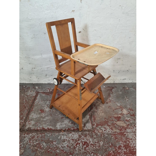 22 - A mid 20th century beech metamorphic child's highchair - approx. 96cm high