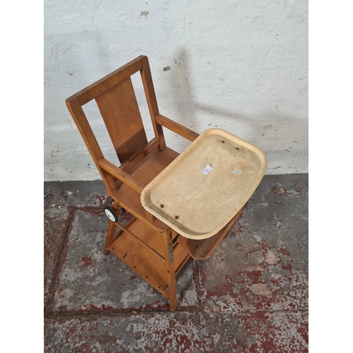 22 - A mid 20th century beech metamorphic child's highchair - approx. 96cm high