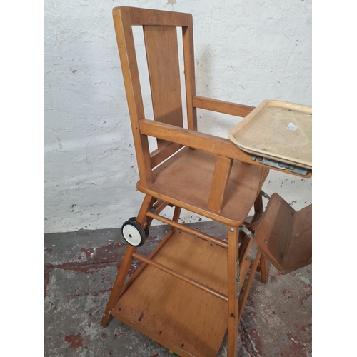 22 - A mid 20th century beech metamorphic child's highchair - approx. 96cm high