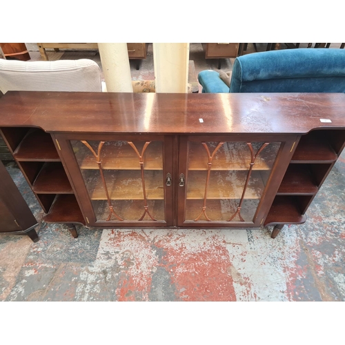 26 - An Edwardian style mahogany two door glazed bookcase with three internal shelves and six outer shelv... 