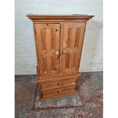 38 - A modern pine two door cabinet with two lower drawers - approx. 119cm high x 70cm wide x 44cm deep