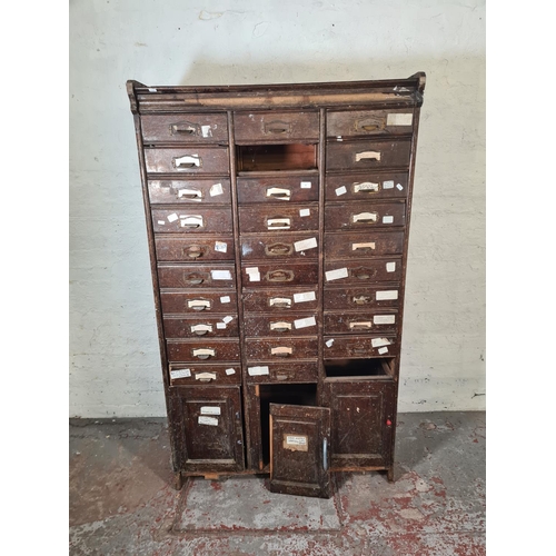 43 - An early 20th century oak thirty drawer haberdashery cabinet - approx. 180cm high x 104cm wide x 41c... 