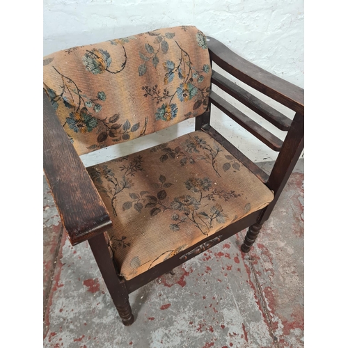 45 - An early 20th century oak and floral upholstered height adjustable armchair - approx. 68cm high x 57... 