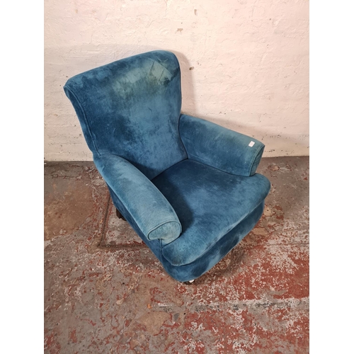 46 - A Victorian blue fabric upholstered armchair with mahogany supports and castors - approx. 96cm high ... 