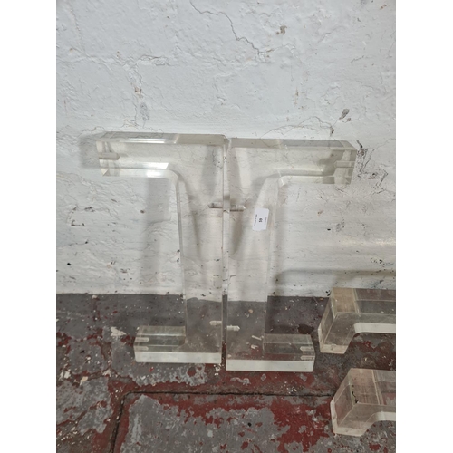 59 - Four mid 20th century lucite table supports, two 45cm and two 100cm