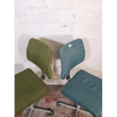 65 - A pair of mid 20th century steel and fabric upholstered swivel desk chairs