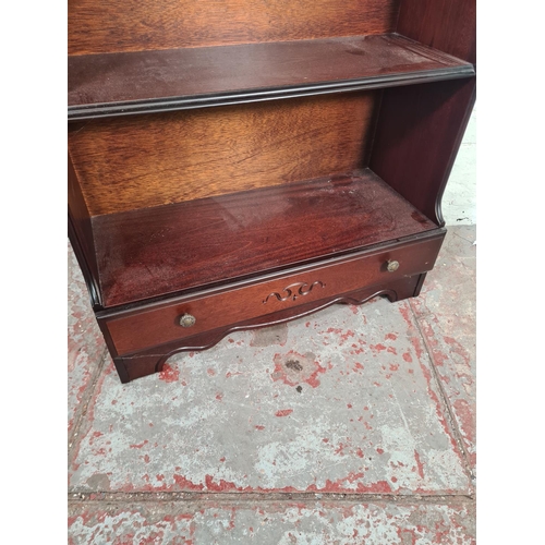 69 - A Rossmore Furniture mahogany four tier waterfall bookcase with lower drawer - approx. 118cm high x ... 