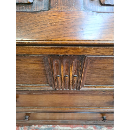 73 - An oak linenfold bureau with three drawers and fall front - approx. 100cm high x 76cm wide x 43cm de... 