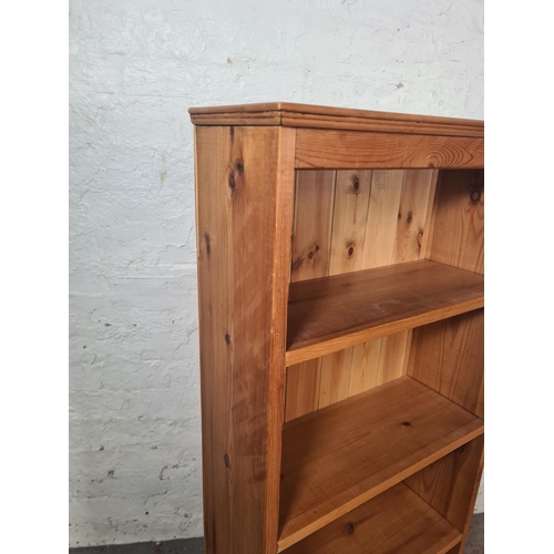 8 - A modern solid pine four tier freestanding bookcase - approx. 122cm high x 59cm wide x 23cm deep