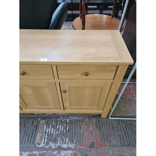 86 - A modern oak effect sideboard with three drawers and three cupboard doors - approx. 77.5cm high x 13... 