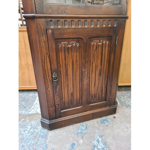 91 - An oak linenfold freestanding corner cabinet - approx. 176cm high x 71cm wide x 40cm deep