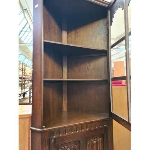 91 - An oak linenfold freestanding corner cabinet - approx. 176cm high x 71cm wide x 40cm deep