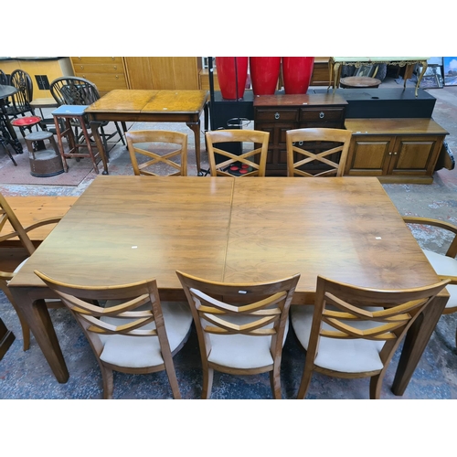 94 - A modern walnut rectangular extending dining table and eight matching chairs - approx. 75.7cm high x... 