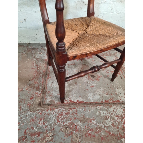 96 - A 19th century mahogany and rush seated armchair - approx. 83cm high x 51cm wide x 43cm deep