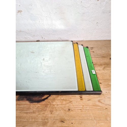 185 - An Art Deco style tinted glass and bevelled edge wall mirror - approx. 85cm wide x 41cm high