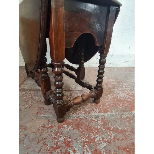 81A - A 19th century oak drop leaf gate leg dining table with later added top