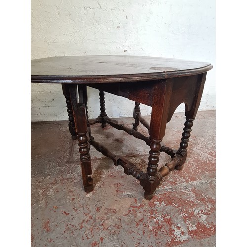 81A - A 19th century oak drop leaf gate leg dining table with later added top