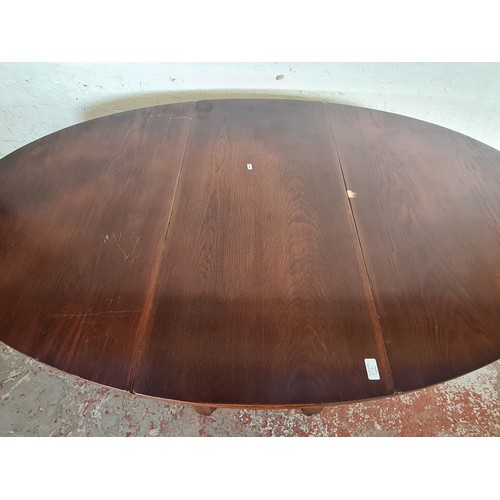 81D - An oak drop leaf gate leg oval dining table