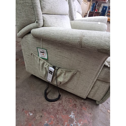 127B - A Sherborne green fabric upholstered electric reclining armchair with remote and power adaptor