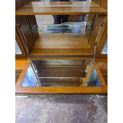 127C - A modern teak effect display cabinet with two upper glazed doors, fall front, four drawers and four ... 