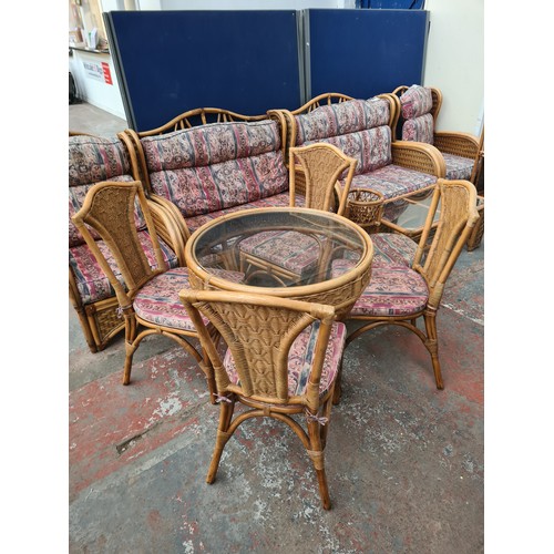 58A - A bamboo and wicker thirteen piece conservatory suite comprising two sofas, two armchairs, four tier... 